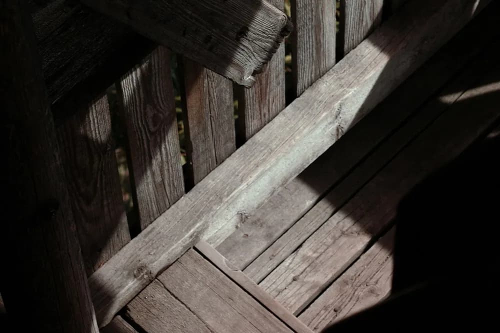 Planches et solives anciennes dans une lumière rasante